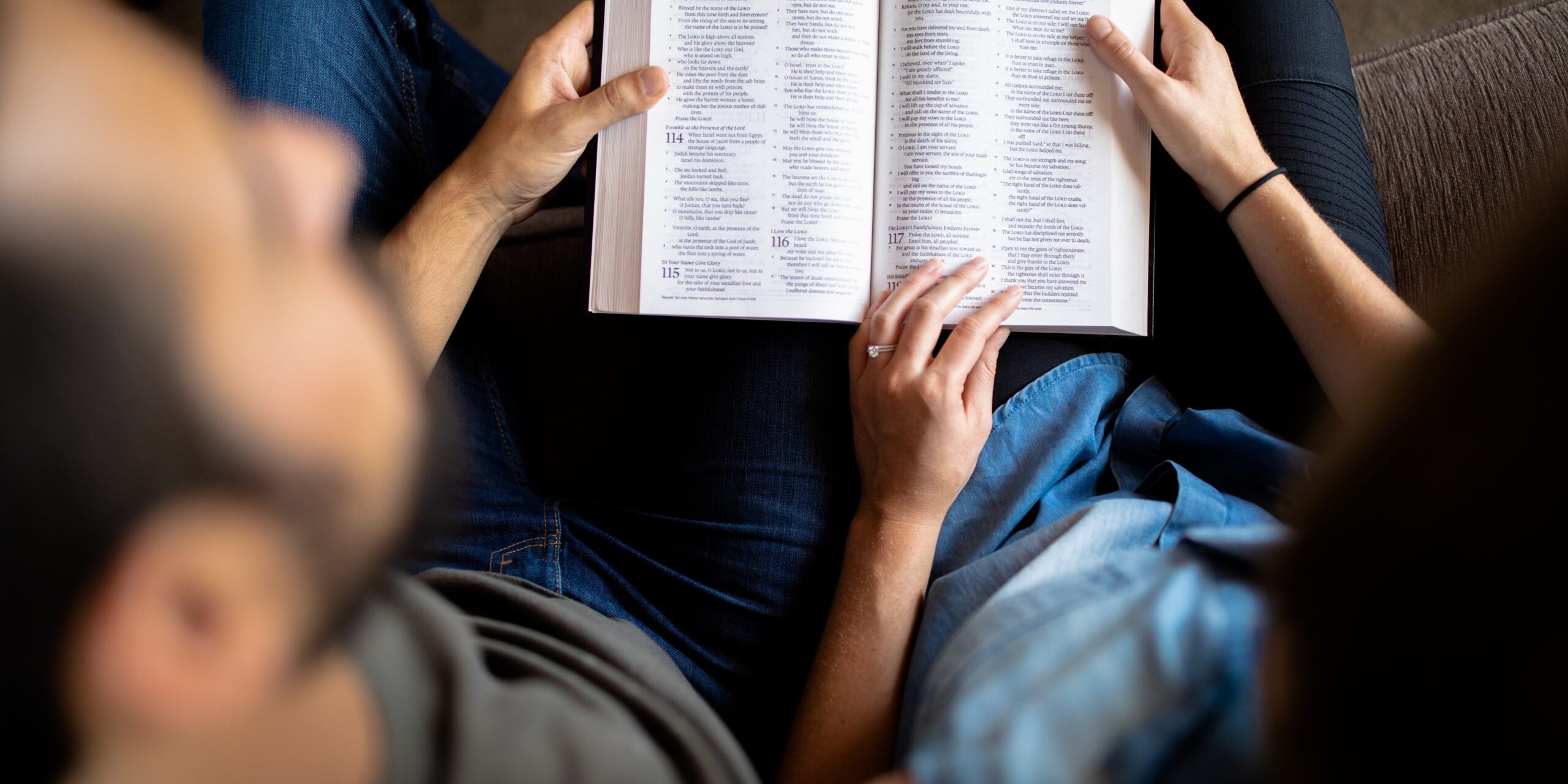 couple reading book on couch